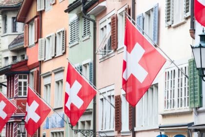 Zurich layover guide photo of the Swiss flag on buildings in Old Town Zurich.