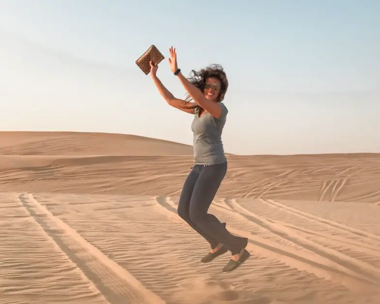 Me jumping in the desert in Abu Dhabi a top solo female travel destinations