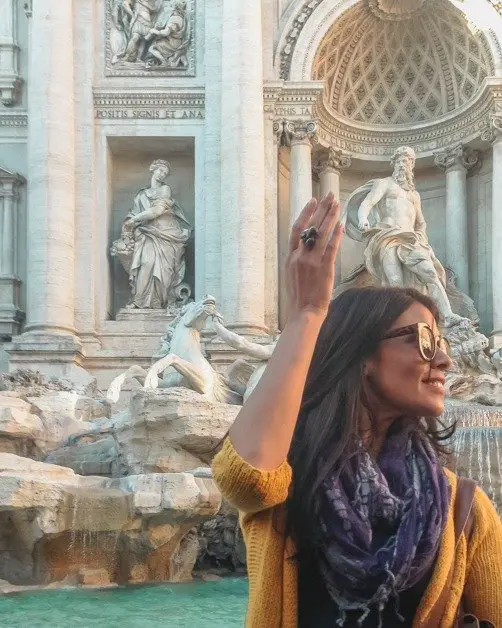 Me throwing a penny in the Trevi fountain in Rome an awesome solo female travel destinations