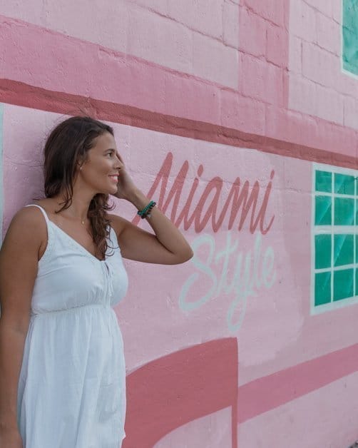 Me posing in front of a colorful wall outside of club Space one of the best places to take pictures in Miami.