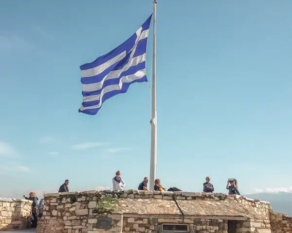 Picture of the Greek flag at the Acropolis one of the things to do in Athens, Greece