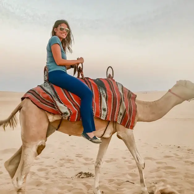 Riding a camel in the desert in Abu Dhabi one of the best solo female travel destinations