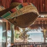 Sombrero hanging from the ceiling with the ocean in the background