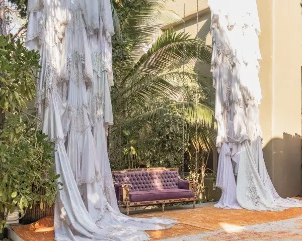 Extravagant sofa with hanging wedding dresses. Entrance into Casa Malca 