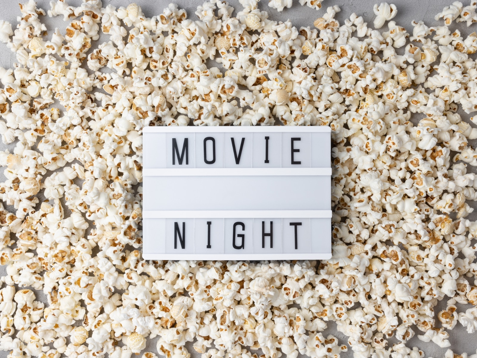Travel movies photo of popcorn and sign that says movie night.
