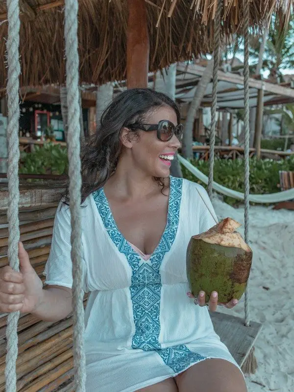  Me on a swinging near beach hut holding a coconut on one of the Tulum beaches