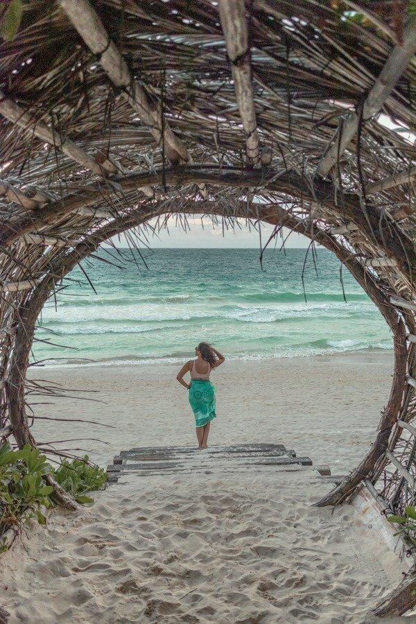 Looking at the beach in front of a wooden tunnel