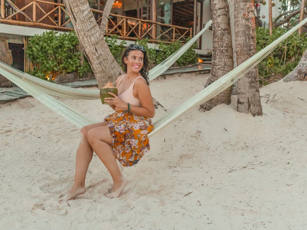 Me posing on a hammock with a coconut.