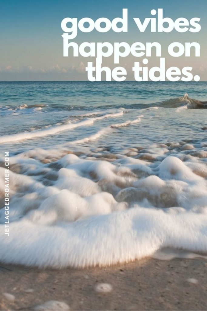 Foamy shoreline on a sunny day and a quote "good vibes happen on the tides."