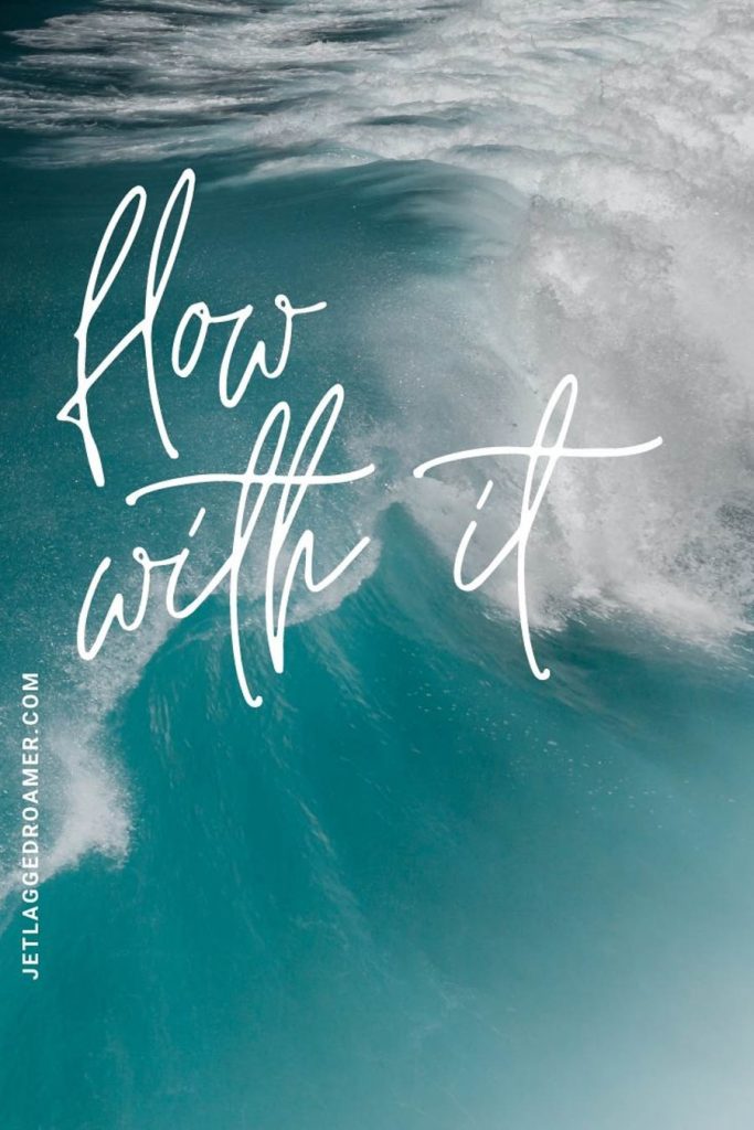 Aerial view of a wave in the ocean and a beach quote that says "flow with it!"