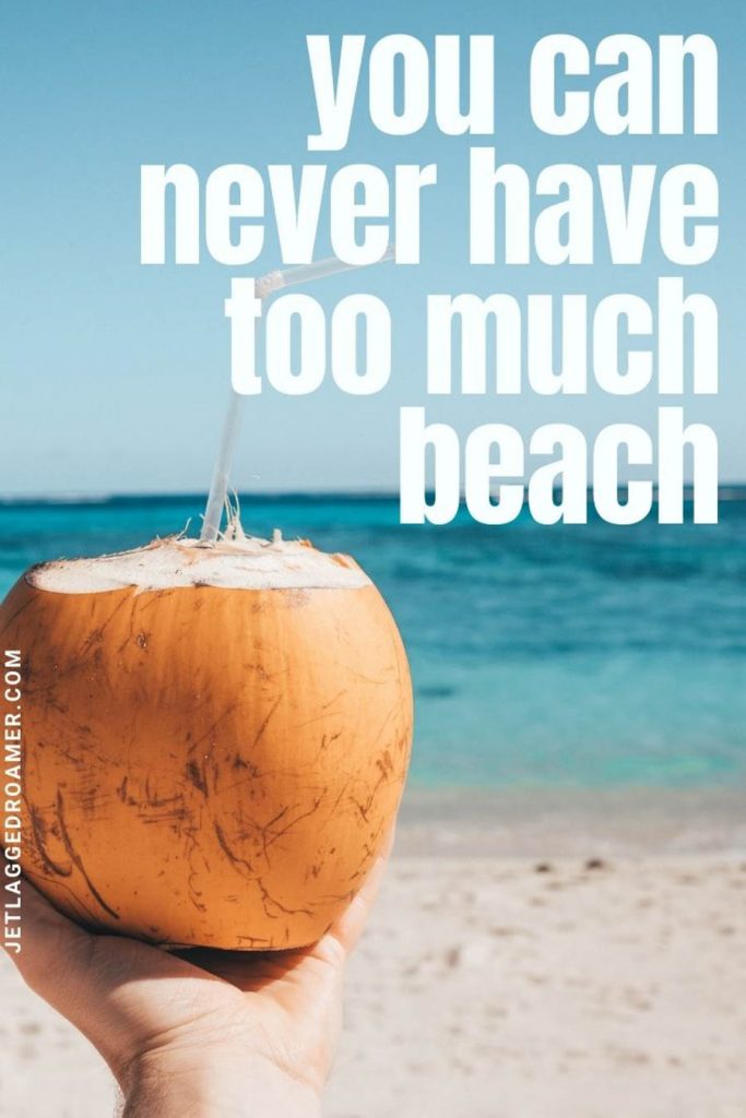 Someone holding a coconut with a straw in front of the beach and a quote with "you can never have too much beach."