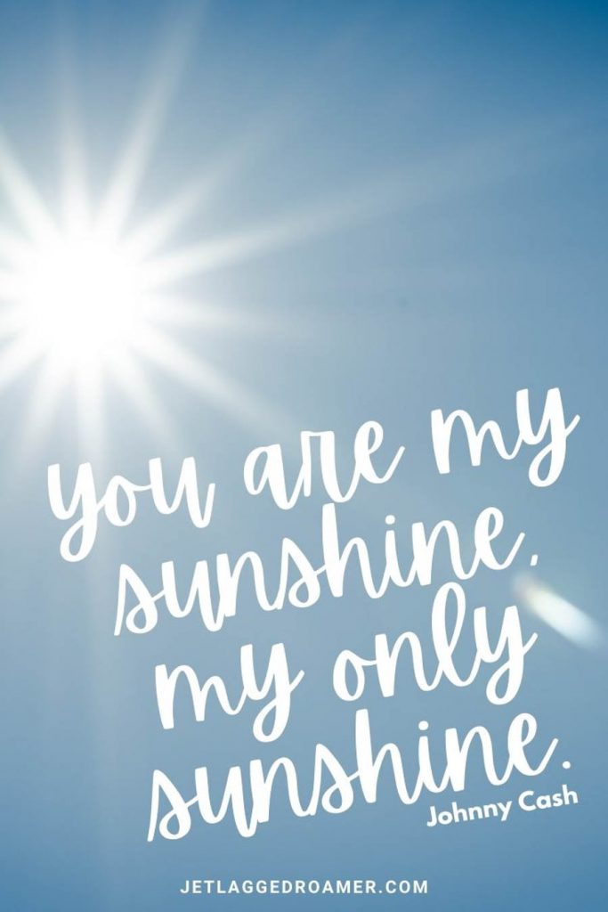 Bright sun in a blue sky with a summer caption from Johnny Cash "You are my sunshine, my only sunshine. "