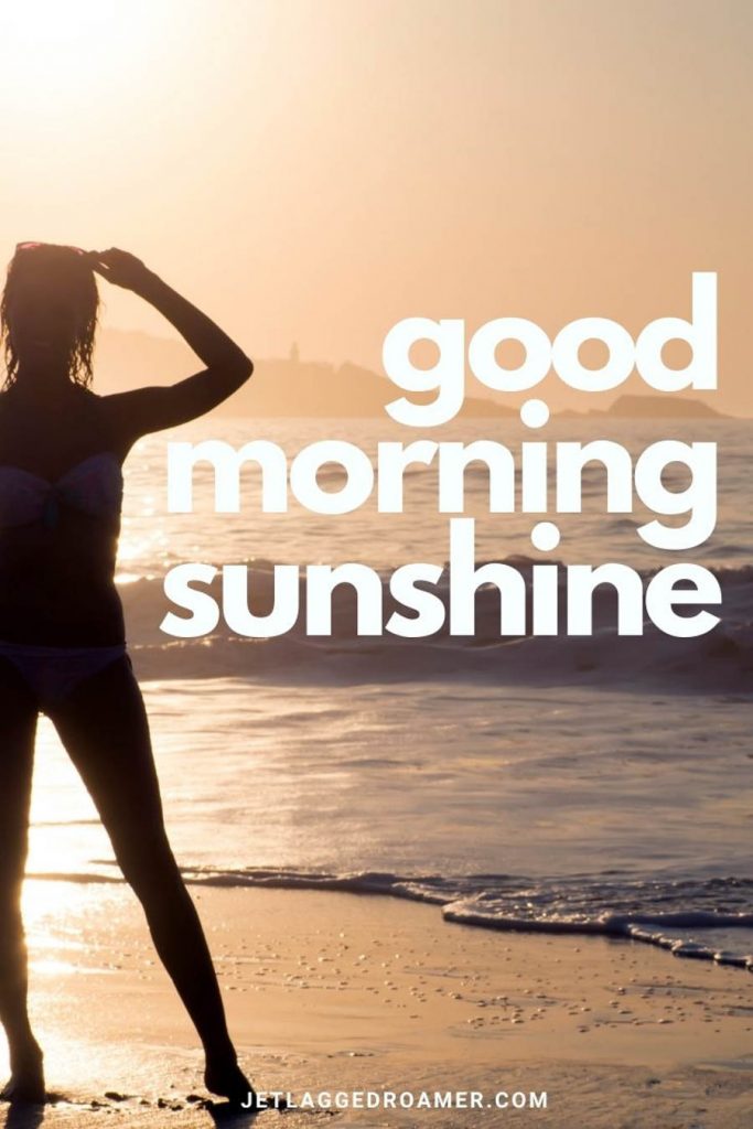 Woman at the beach dressed in her surfer wet suit staring at the sunrise and text that says "good morning sunshine."