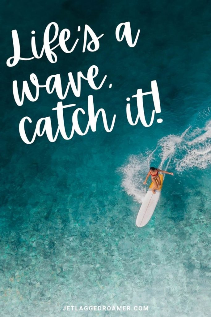 Woman surfing on a deep blue ocean and a phrase that says "life's a wave, catch it!"