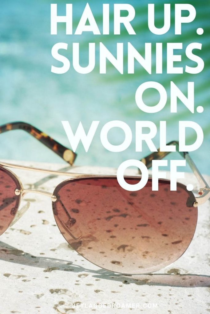 Sunglasses perched next to a pool and a summer Instagram caption that reads 