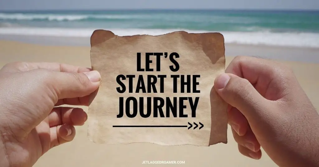 Man holding  a quote that says "Let's start the journey" in front of the ocean one of the traveling hacks