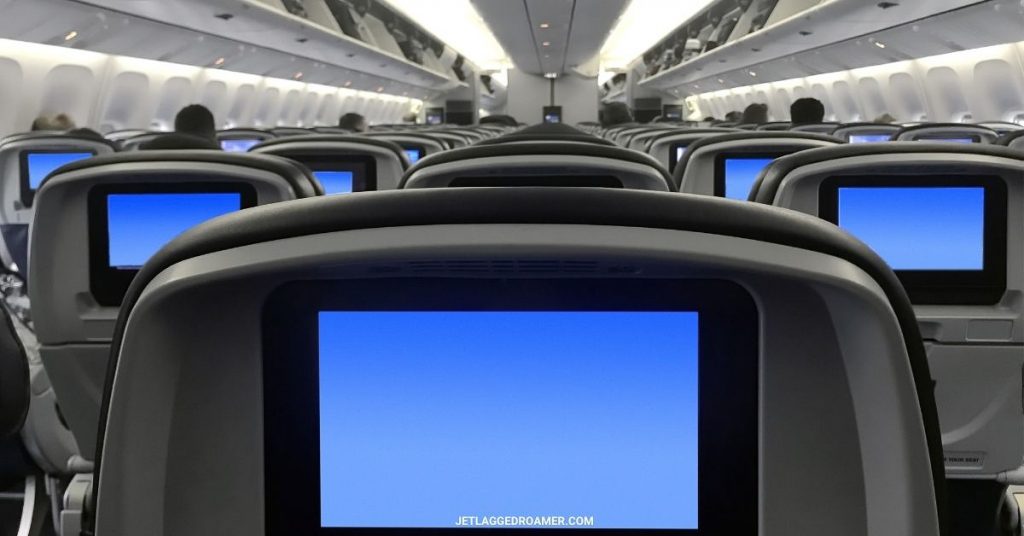 Large plane facing the front and screens on the tv shining bright blue