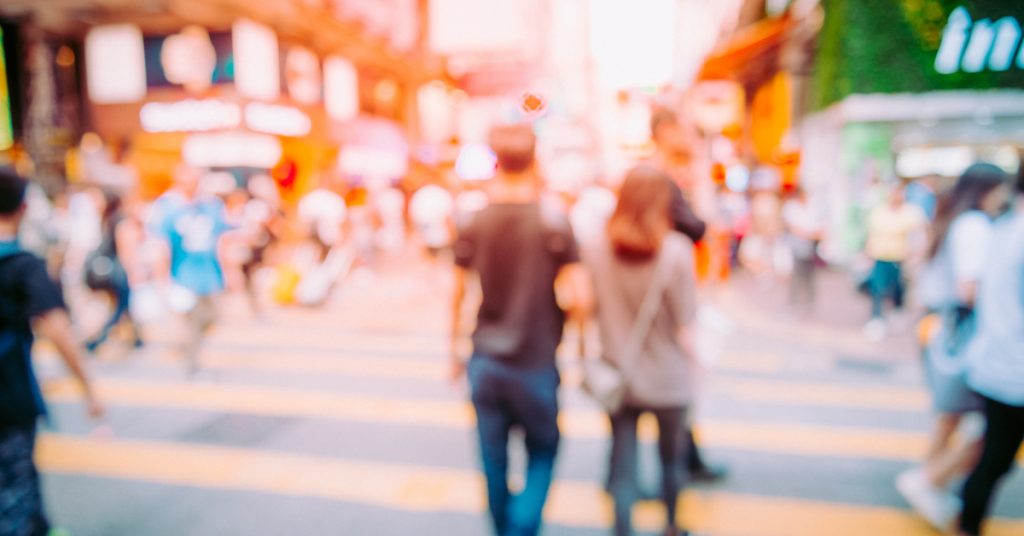 Picture for travel terms of people walking on a busy street in a city somewhere.