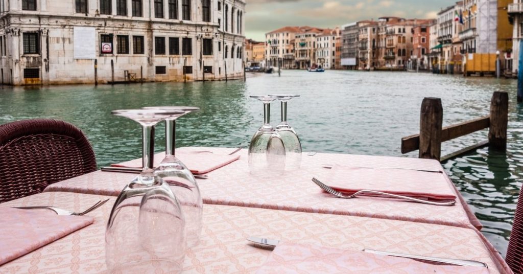 Beautiful table overlooking a canal in Italy for a travel phrases photo. 