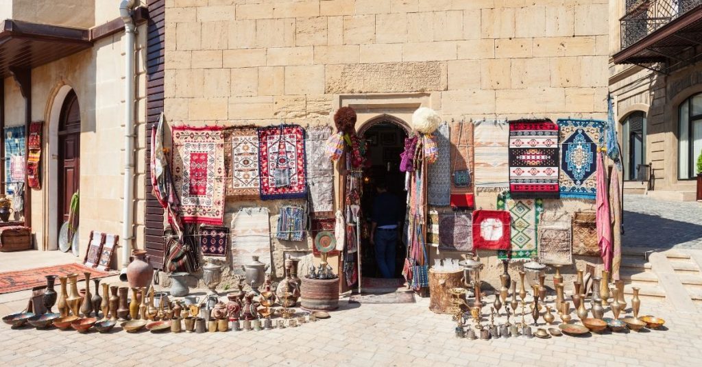 Travel expressions photo. Outside of a market with a rug and other souvenirs in the middle east on a sunny day.  