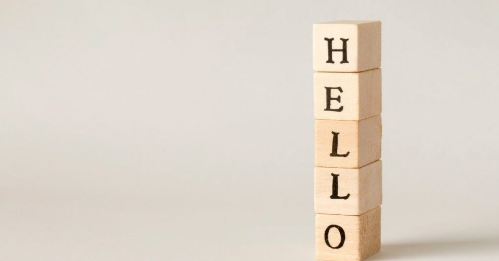 Greet and farewell travel terms photo. Mini blocks stacked vertically with the word hello.
