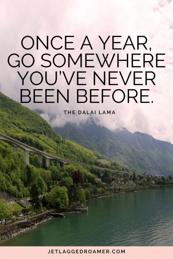 funny travel quote that says “Once a year, go somewhere you’ve never been before" with picture of Switzerland's green mountains and a river.