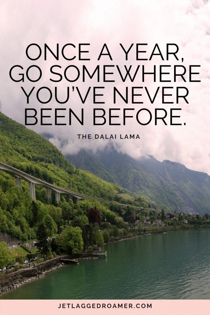 funny travel quote that says “Once a year, go somewhere you’ve never been before" with picture of Switzerland's green mountains and a river. 