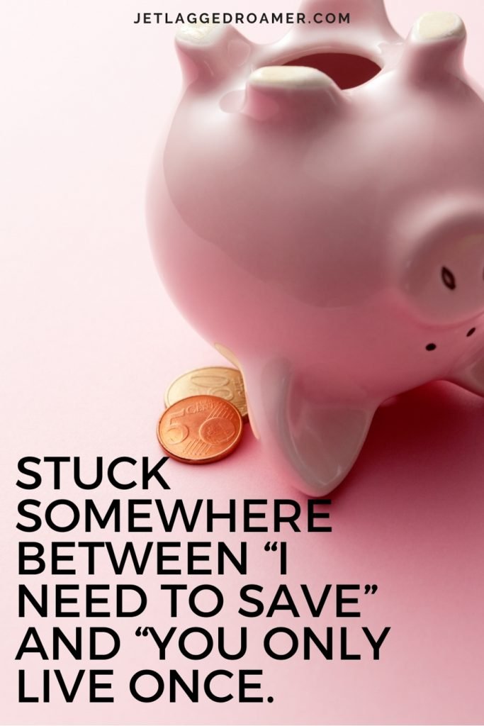 Pink piggy bank with a few coins and funny travel quote “Stuck somewhere between “I need to save” and “you only live once.”