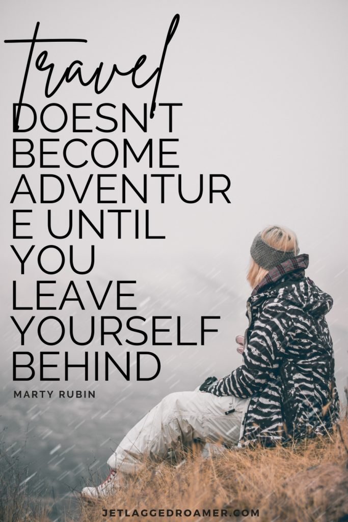 Quote reads “Travel doesn’t become adventure until you leave yourself behind" by Marty Rubin. Woman siting by herself on a mountain on a foggy day. 