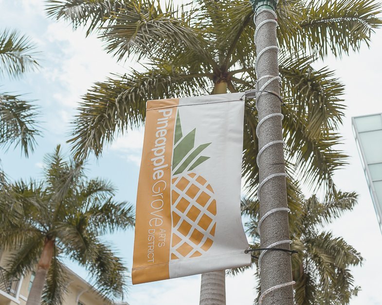 Sign with a pineapple entering into Pineapple Grove in Delray Beach. 