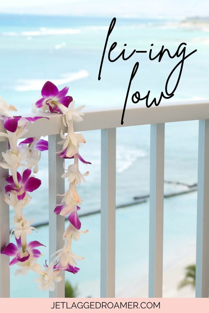 Hawaii pun that says lei-ing low. Beach with a lei. 