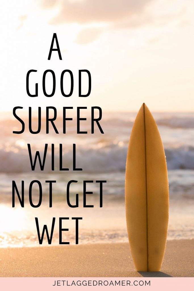 Surfboard on the beach and a Hawaiian proverb that reads A good surfer will not get wet.