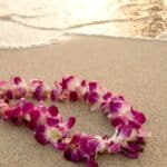 Things to do in Oahu photo of a Hawaiian lei on the beach.