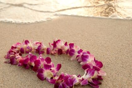 Things to do in Oahu photo of a Hawaiian lei on the beach.