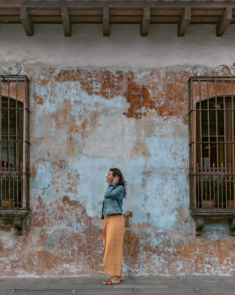 Me posing on one of the colorful buildings in Antigua.
