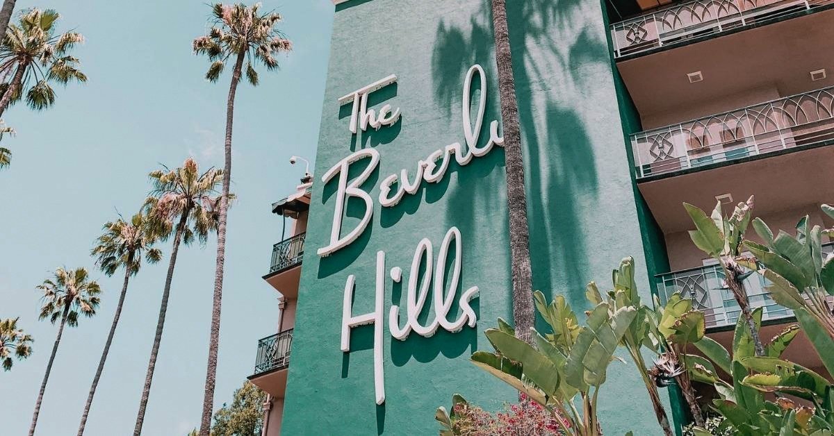 Beverly Hills Captions photo of the Beverly Hills Hotel on a sunny day.