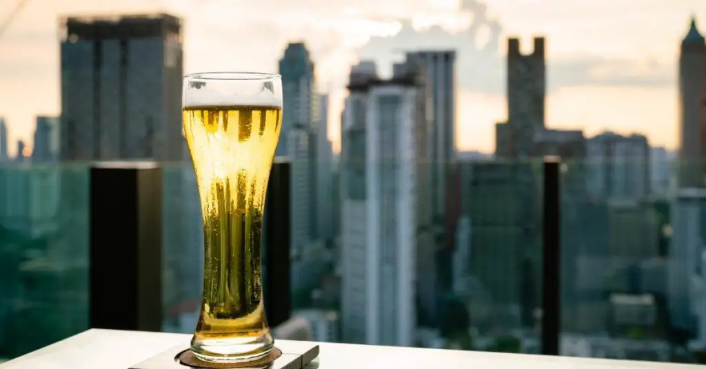 Balcony captions for Instagram photo of a pint of beer from a rooftop looking at the New York City skyline. 