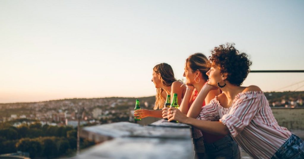 Inspirational rooftop captions photo of friends admiring the rooftop view in Europe.