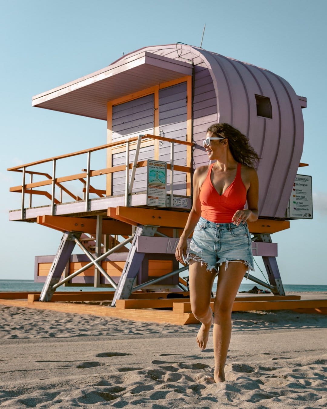 Posing at a lifeguard tower one of the best places to take pictures in Miami. 