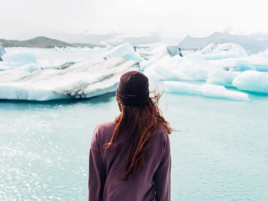 Travel idioms photo of a woman looking at glaciers. 