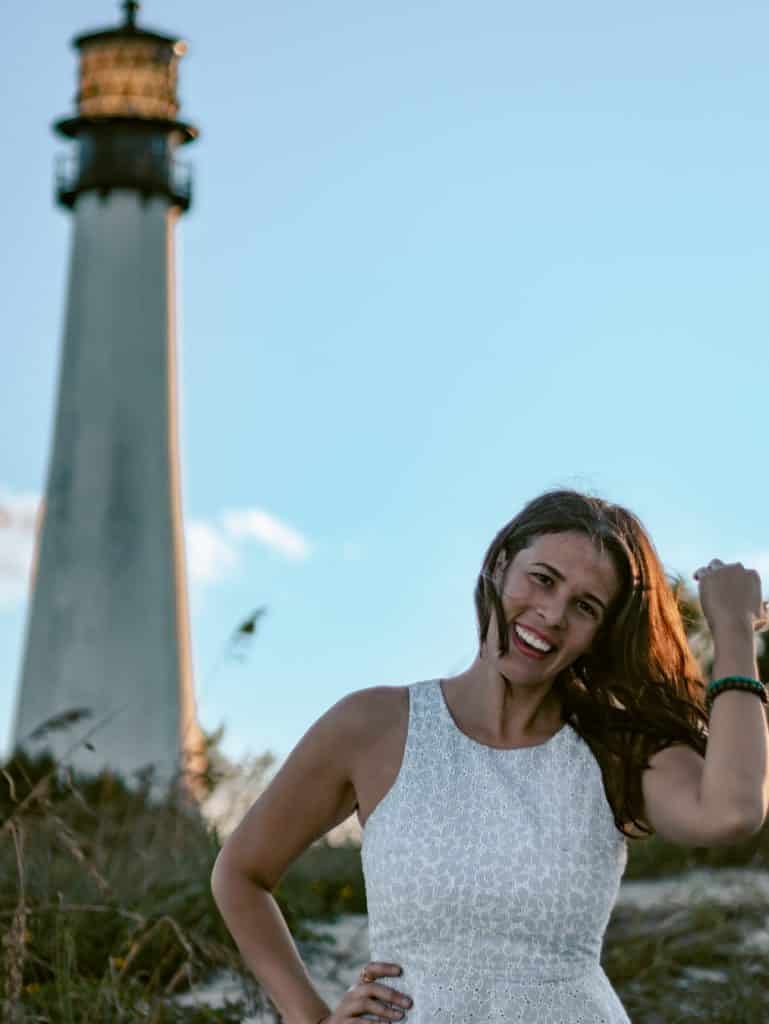 Posing at one of the best places to take pictures in Miami, Bill Baggs State Park in front of the lighthouse. 