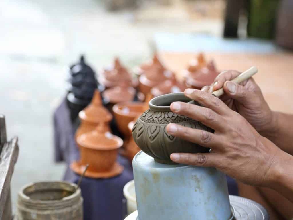 Man painting pottery. 