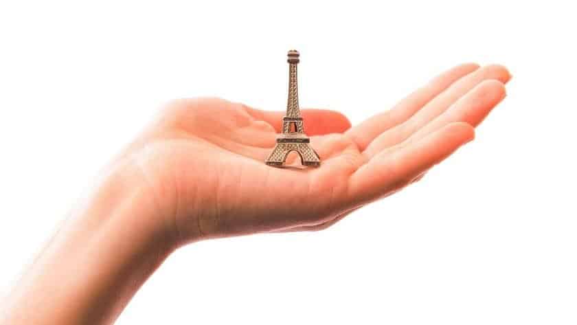 Souvenir Ideas photo of a hand holding a mini figurine of the Eiffel Tower.