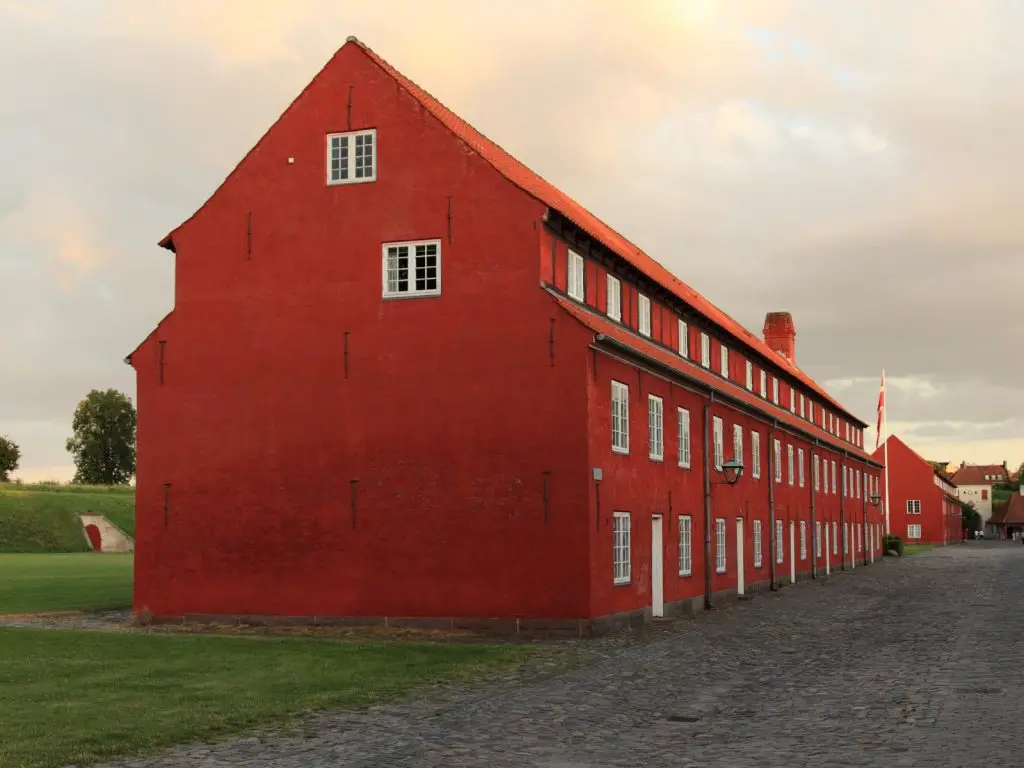 Danish sayings photo of a big red home in the country of Copenhagen, Denmark. 