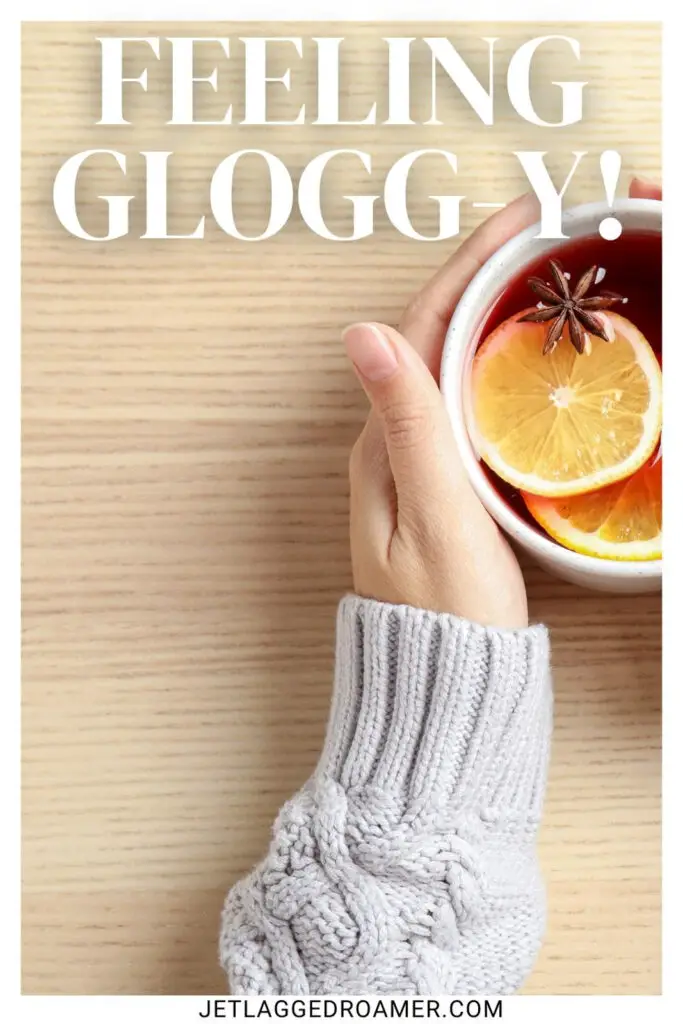 Copenhagen Instagram captions photo of a woman in a sweater holding glogg. Caption says "feeling glogg-y."