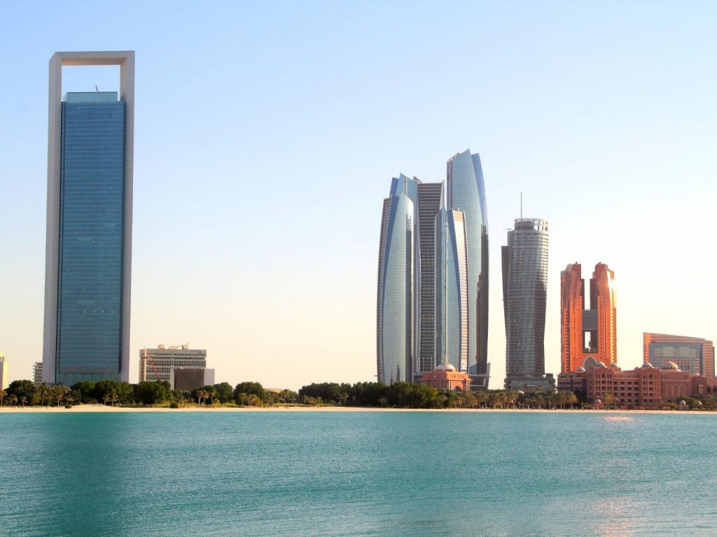 Dress code in Abu Dhabi photo of the skyline of Abu Dhabi from the ocean. 