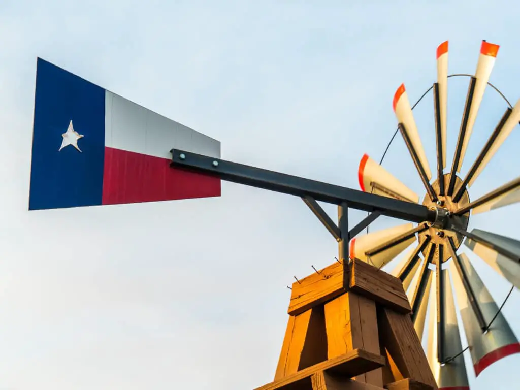 Texas puns photo of a windmill with the Texas flag. 