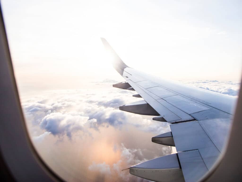 Take care of your skin while traveling photo. Airplane window view. 