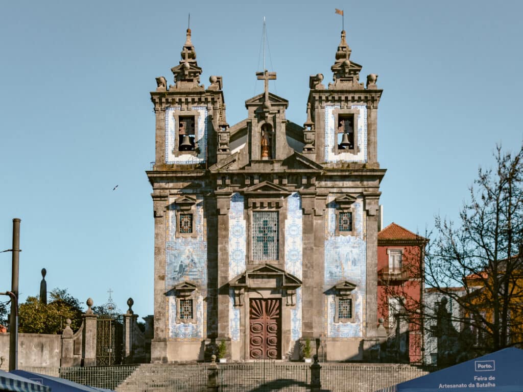 One of the places to see azulejos in Porto Igreja de Santo Ildefonso entrance on a sunny day.