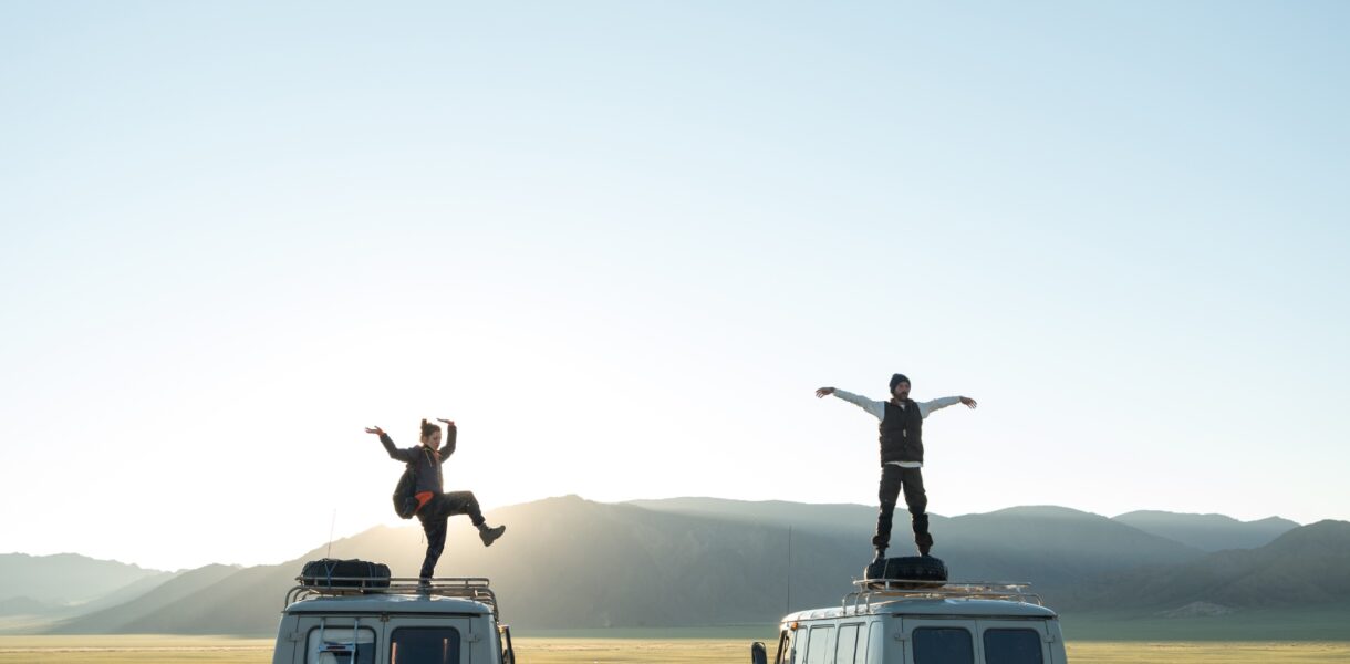 Bucket list captions photo of friends on top of VW vans.